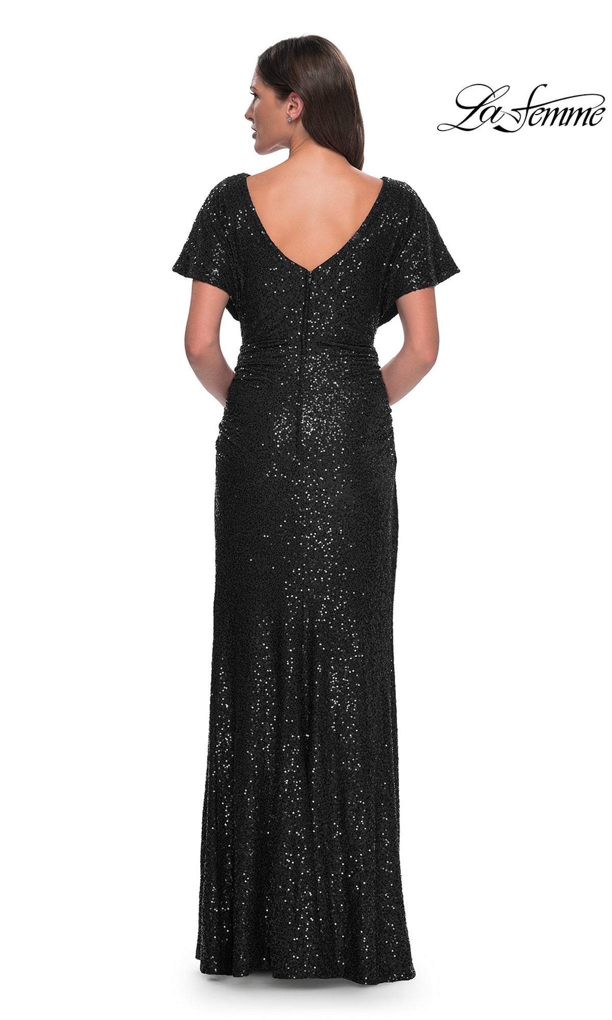 A woman faces away, wearing the La Femme Short-Sleeve Sequin Formal Dress 30885—black, floor-length, fitted, with short sleeves and a deep V-back. The La Femme logo appears in the top right corner.